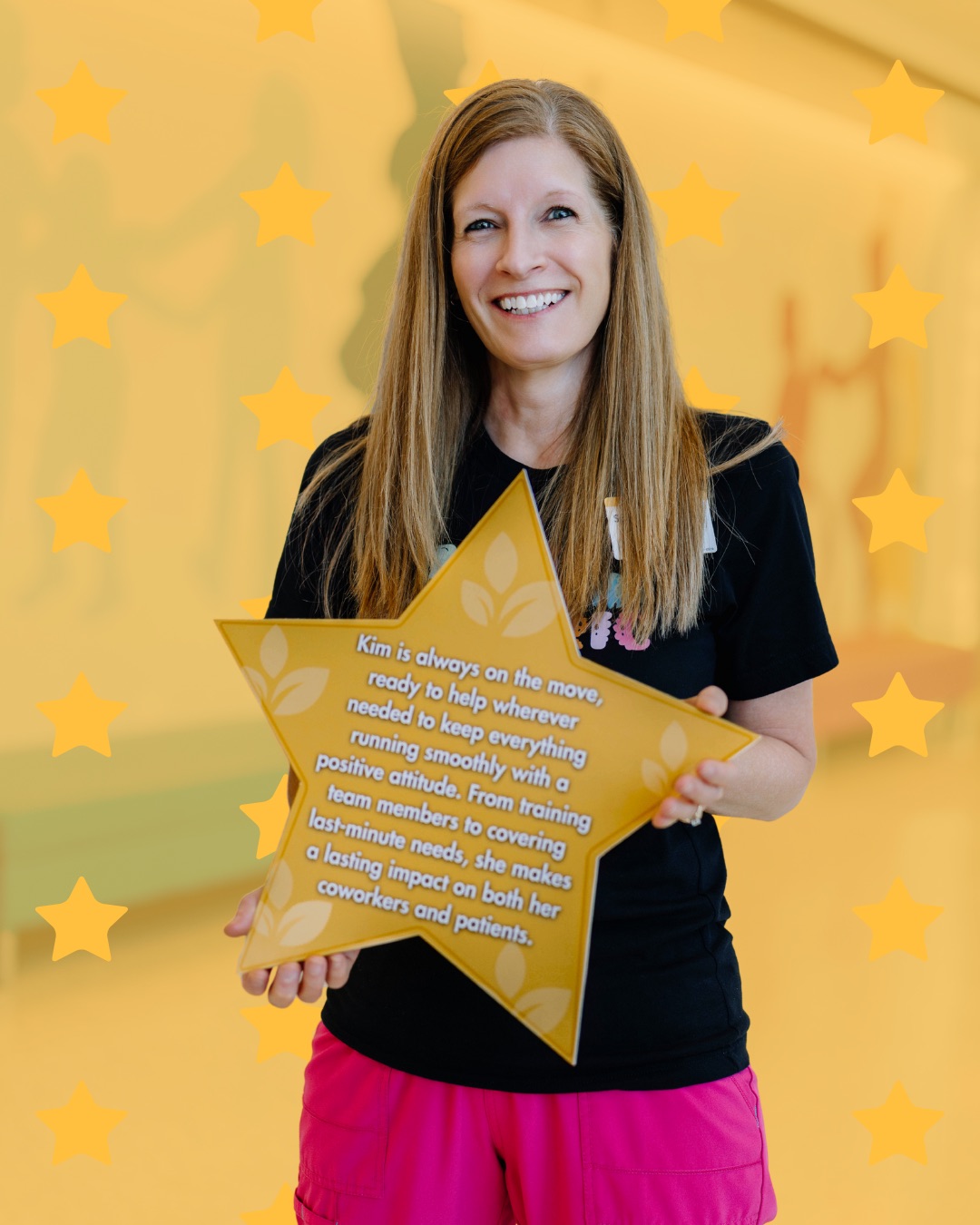 A Springfield Clinic team member holding a gold-star recognition award